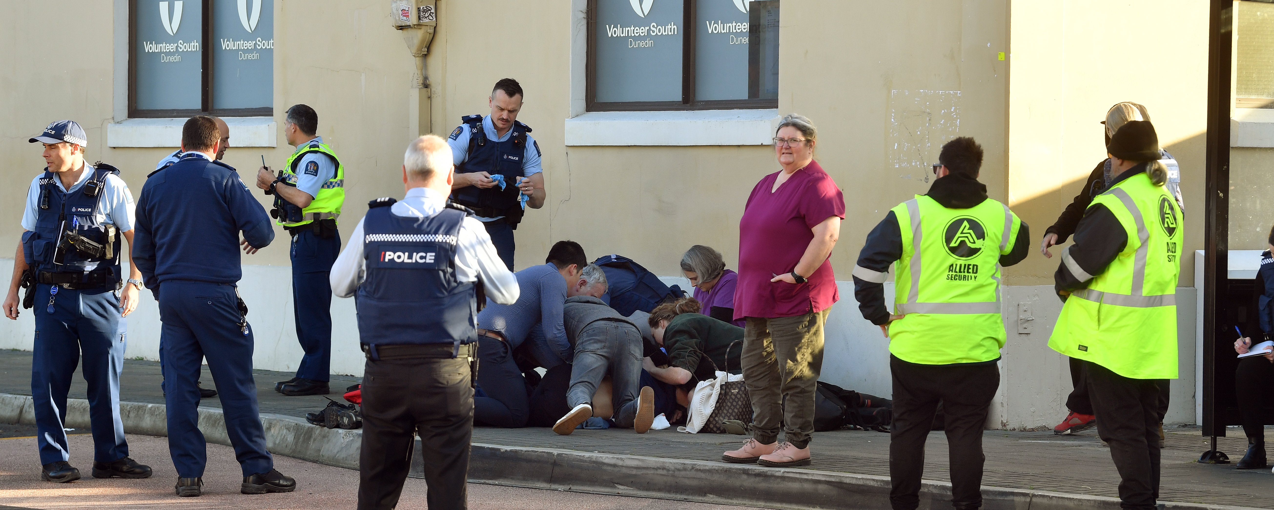 People assist the attacked teenager at the bus hub on Thursday afternoon. PHOTO: STEPHEN JAQUIERY