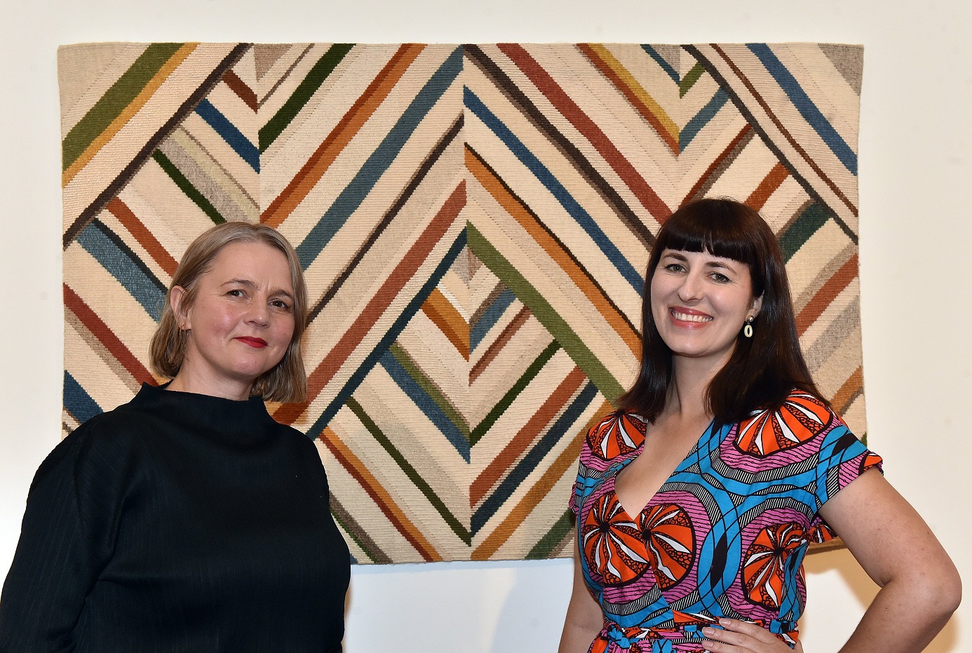 Curators Elle Loui August (left) and Jane Groufsky in front of Margery Blackman’s From Aramoana....