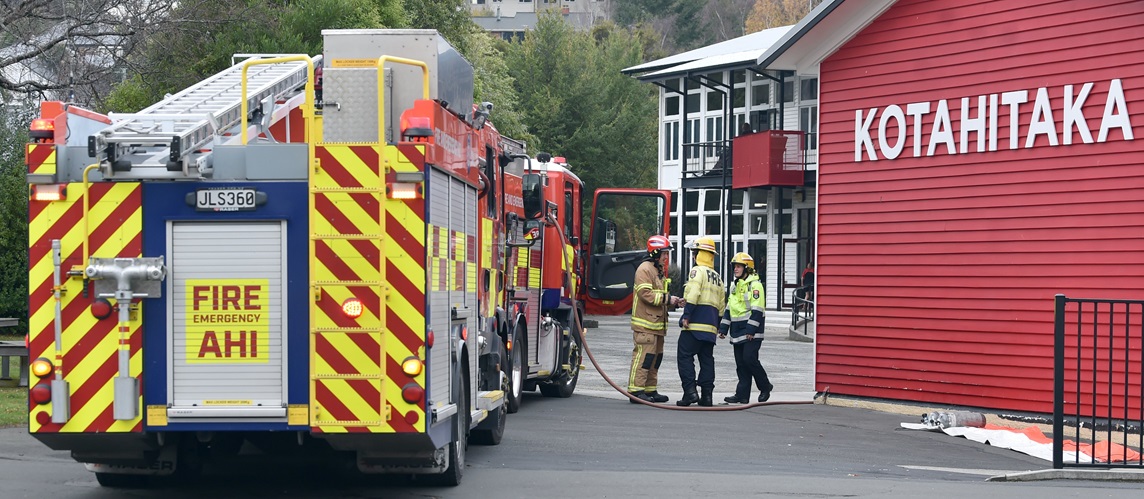 Fire and Emergency NZ personnel at the scene in North Dunedin. Photo: Peter McIntosh