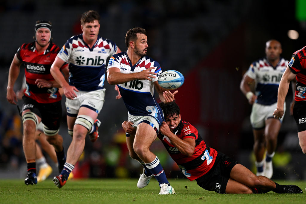 Harry Plummer of the Blues looks to pass during a Super Rugby Pacific game against the Crusaders...