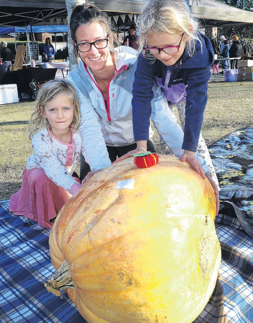Lisa Jordan, Bailee Haughton, 5, and her sister Mila, 7, with the giant pumpkin they grew. PHOTO:...