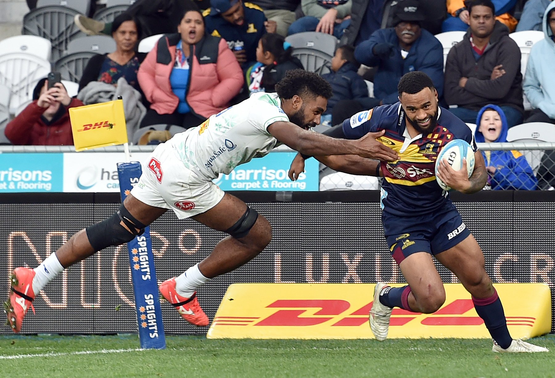 Highlander winger Jona Nareki gets past Fiji Drua Flanker Etonia Waqa to score during Sunday’s...