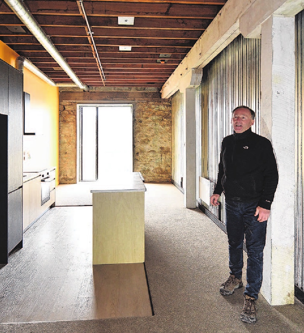 Property developer Russell Lund stands in one of the "five-star" social housing units in his...