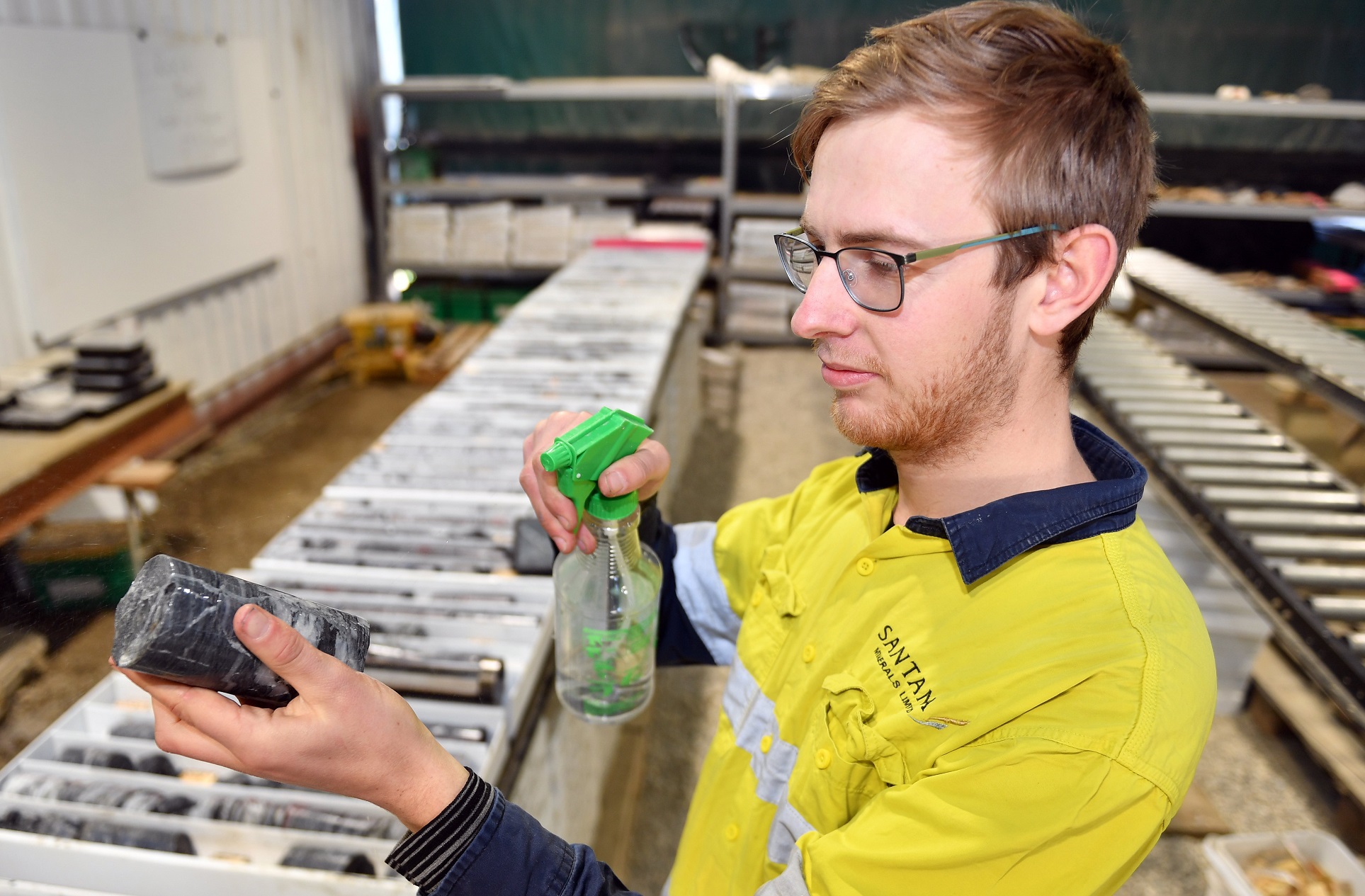 Geologist Tim Campbell logs a drill core sample taken from the Rise and Shine deposit at Santana...