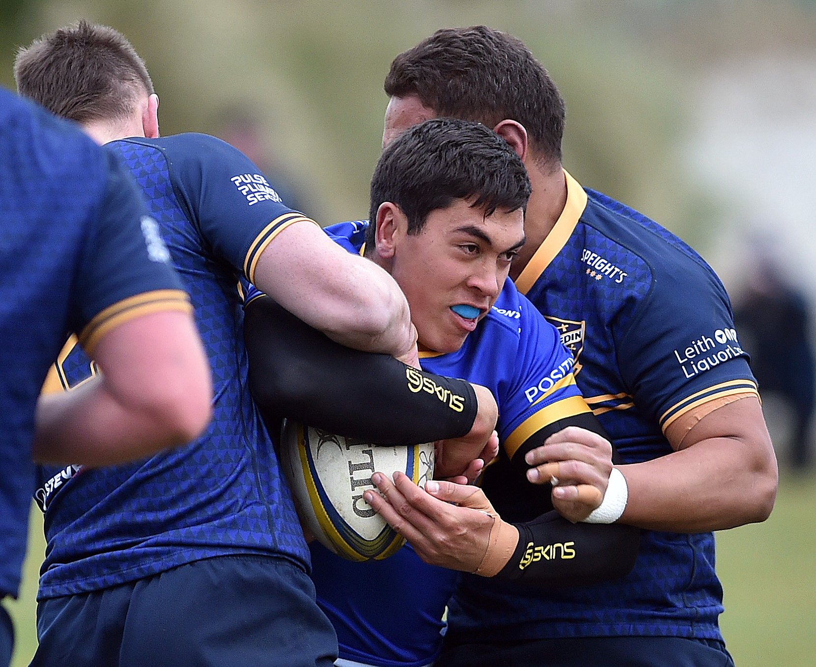 Taieri’s Josh Whaanga is wrapped up by Dunedin’s Joe Cook (left) and Hame Toma during their match...