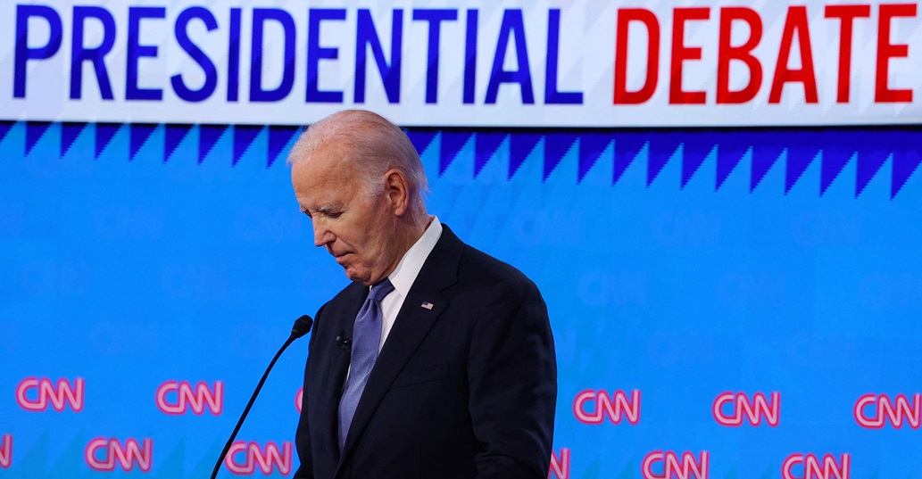 US President Joe Biden listens as rival Donald Trump speaks during their first debate in Atlanta,...