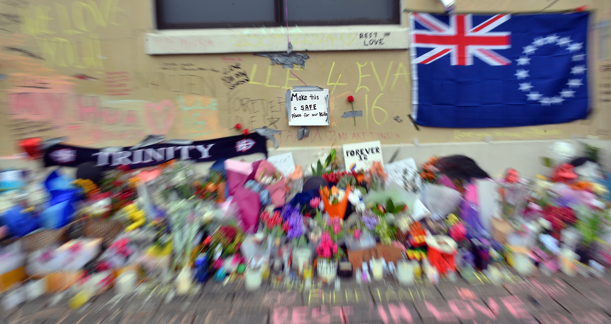 A small sign amidst the memorial messages and flowers at the bus hub, in memory of Enere McLaren...