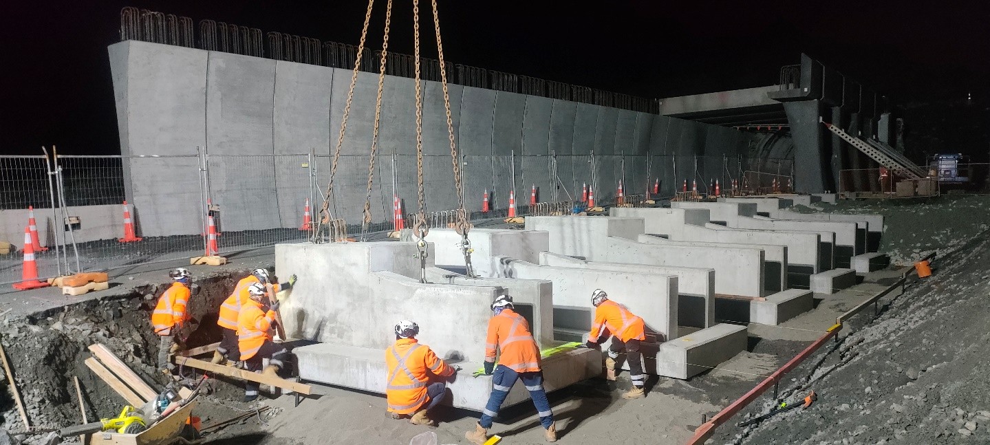 Workers assemble 165 pre-cast concrete modules on site like giant Lego. 