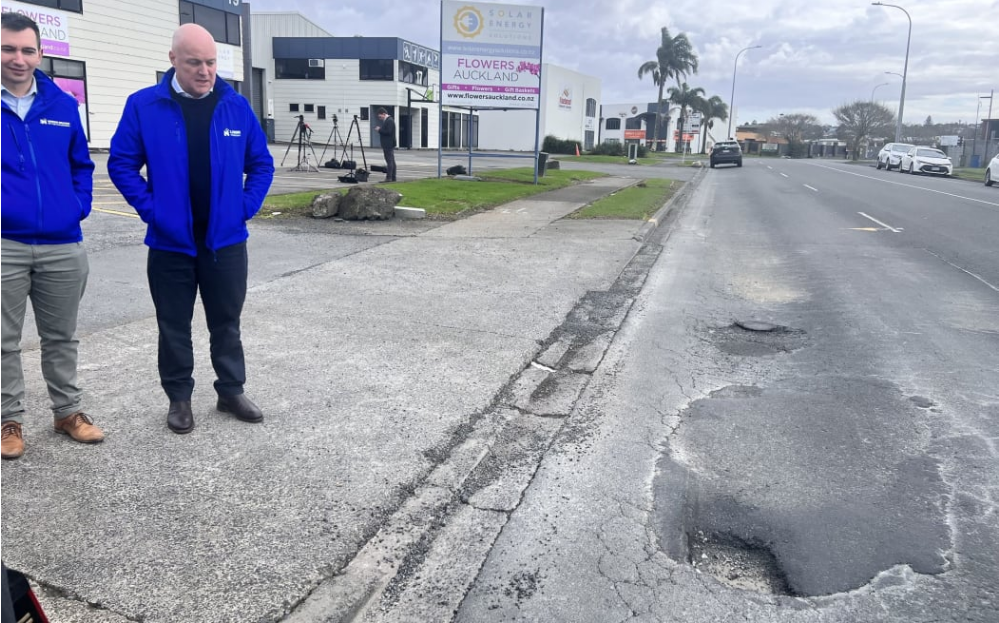 Simeon Brown and Christopher Luxon survey potholes at an earlier announcement. Photo: RNZ