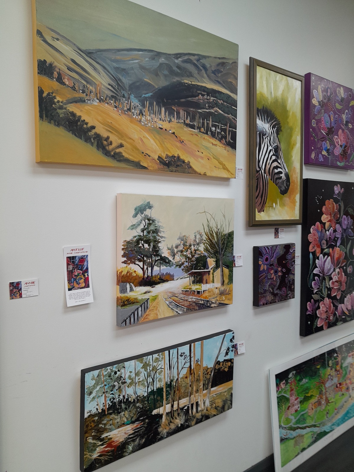 Local artist Annie Hampstead’s landscape paintings at the Creative Us pop-up shop. One of...