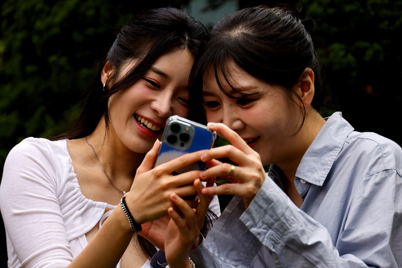 Same-sex couple Kim Eun-ha and Park Cho-hyeon look at pictures on a phone in Suwon, South Korea....