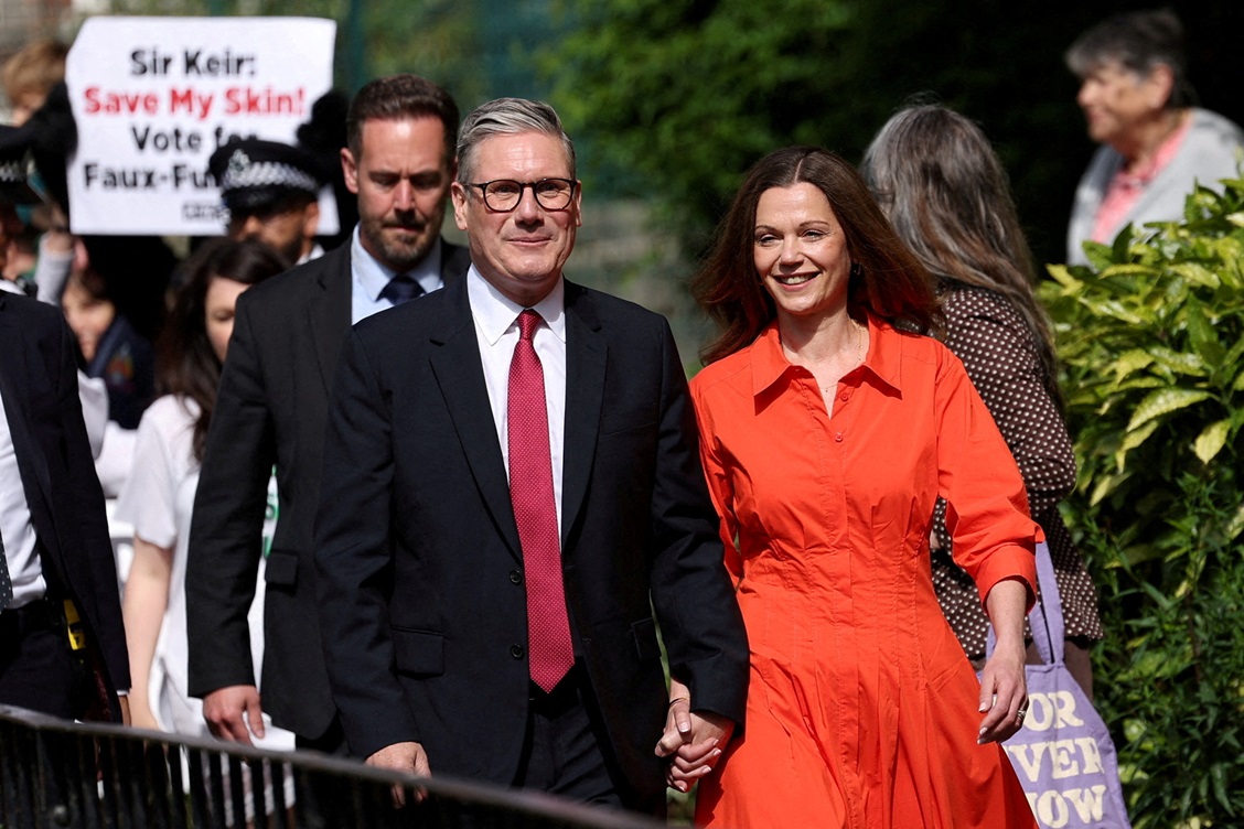 Britain's opposition Labour Party leader Keir Starmer and his wife Victoria walk outside a London...