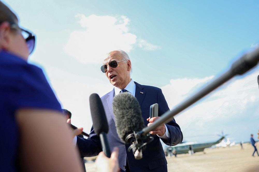 US President Joe Biden speaks to journalists outside Air Force One at Joint Base Andrews in...