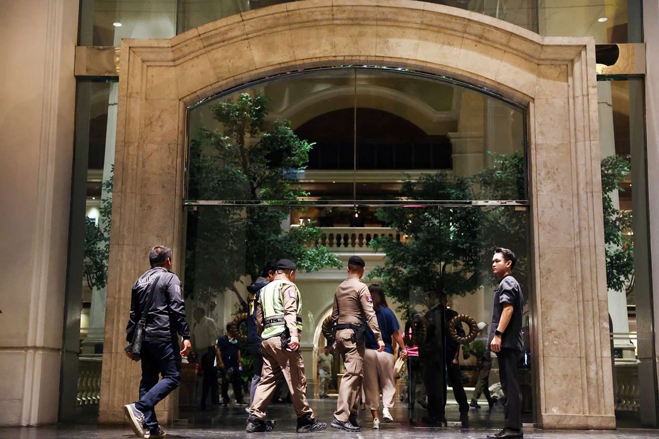 Policemen enter the Grand Hyatt Erawan hotel in Bangkok after six people were found dead inside....