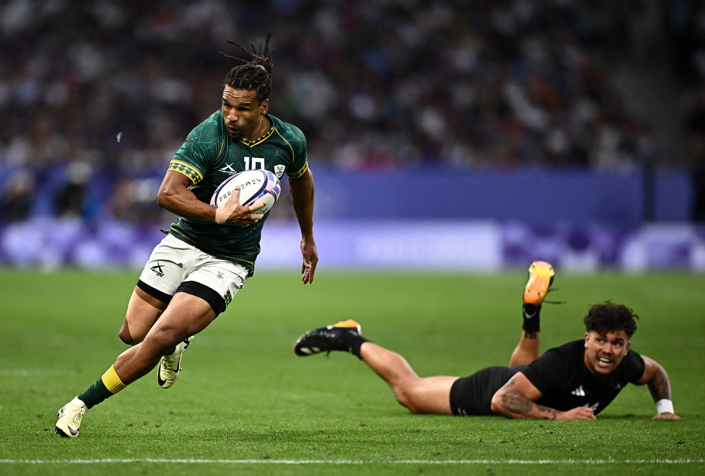 South Africa's Rosko Specman gets past New Zealand's Moses Leo during their quarter-final match...