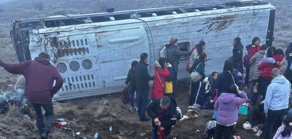 Tourist passengers by one of the buses that crashed on State Highway 8 last week. Photo: Supplied