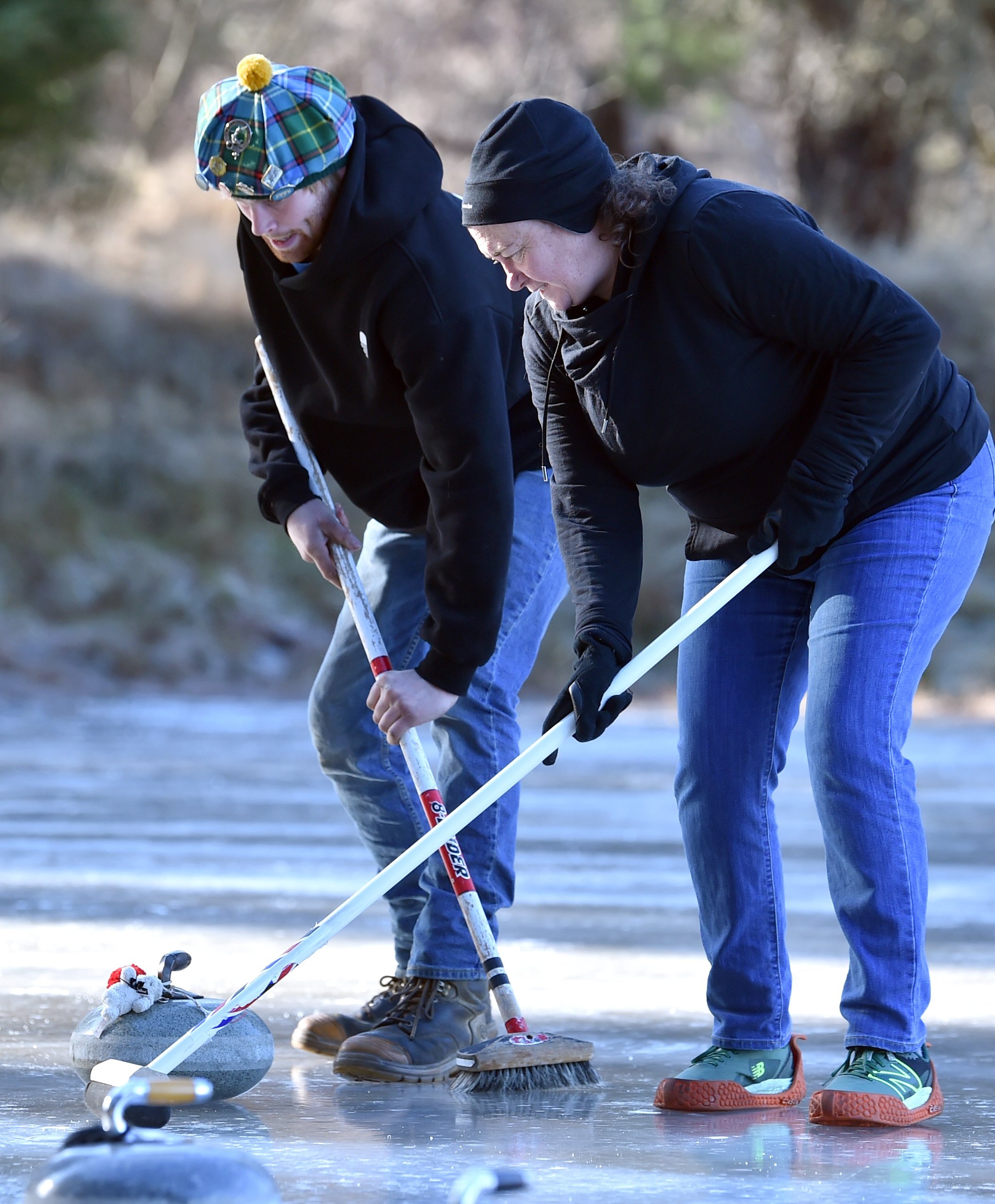 James Ayers and Karen Parker, both of Dunedin, concentrate on sweeping.