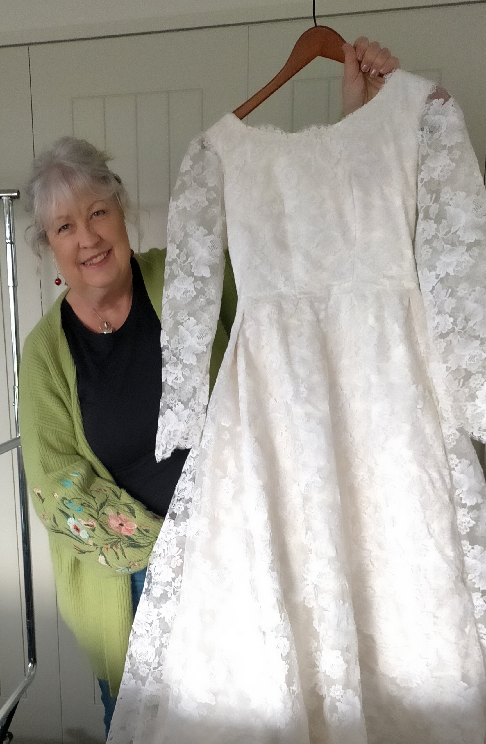 Ange Gibbs holds a wedding gown worn by Coralie Heads on her wedding day in 1965. PHOTO: SUPPLIED