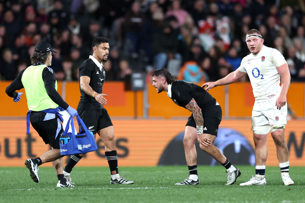 All Blacks halfback TJ Perenara reacts after injuring his knee while playing against England. Photo: Getty