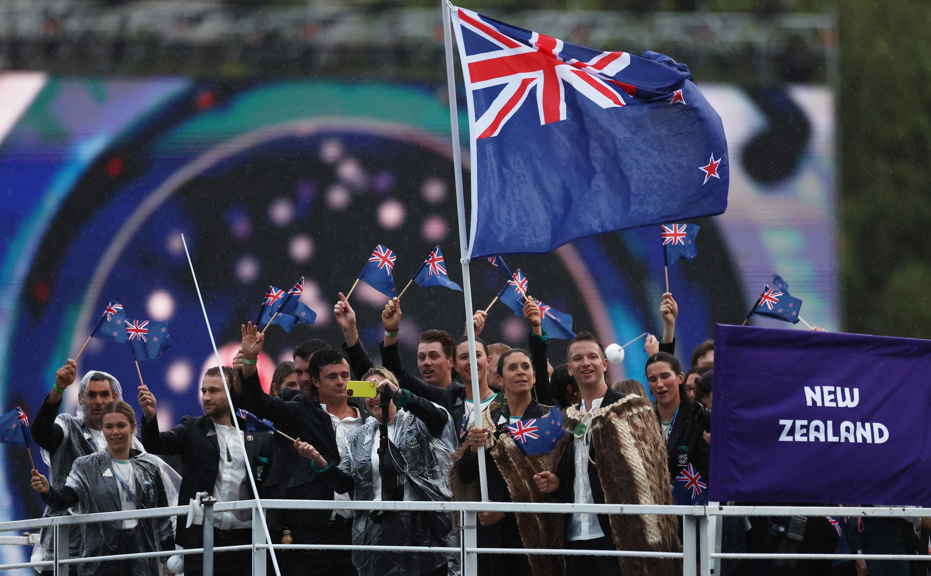 Flagbearers Jo Aleh and Aaron Murray Gate with the New Zealand team on the River Seine during the...