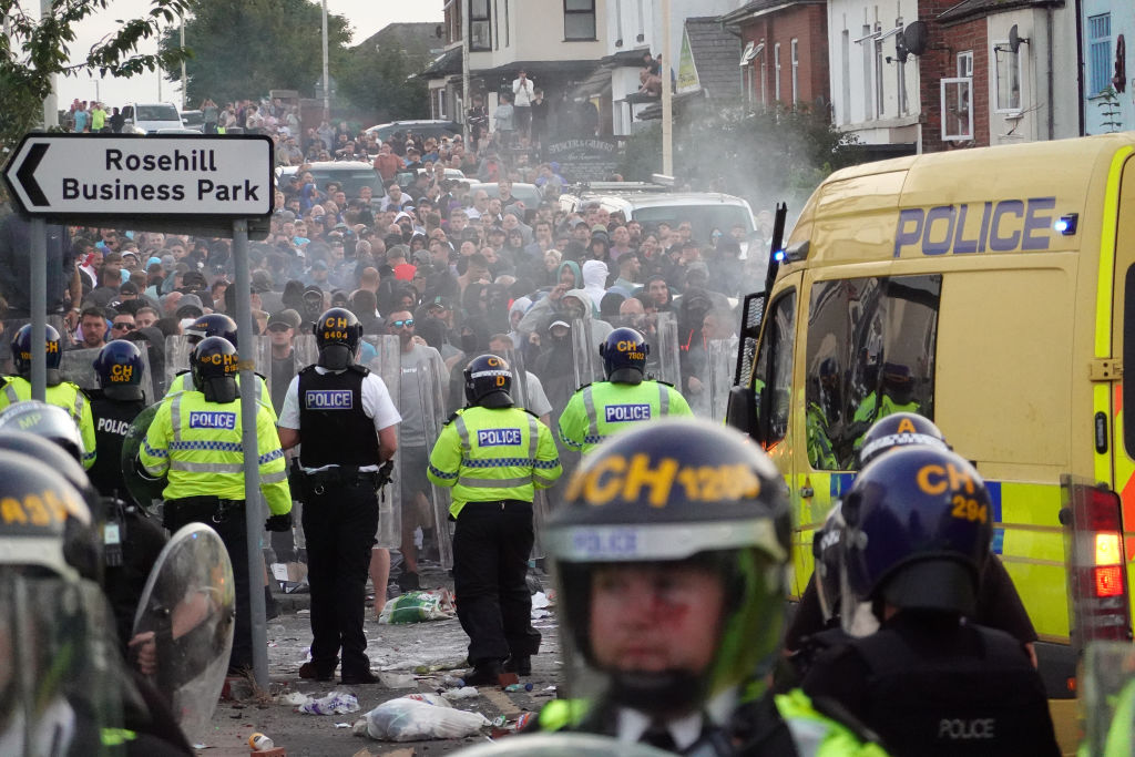 Riot police confront protesters after disorder broke out in Southport following the stabbing...