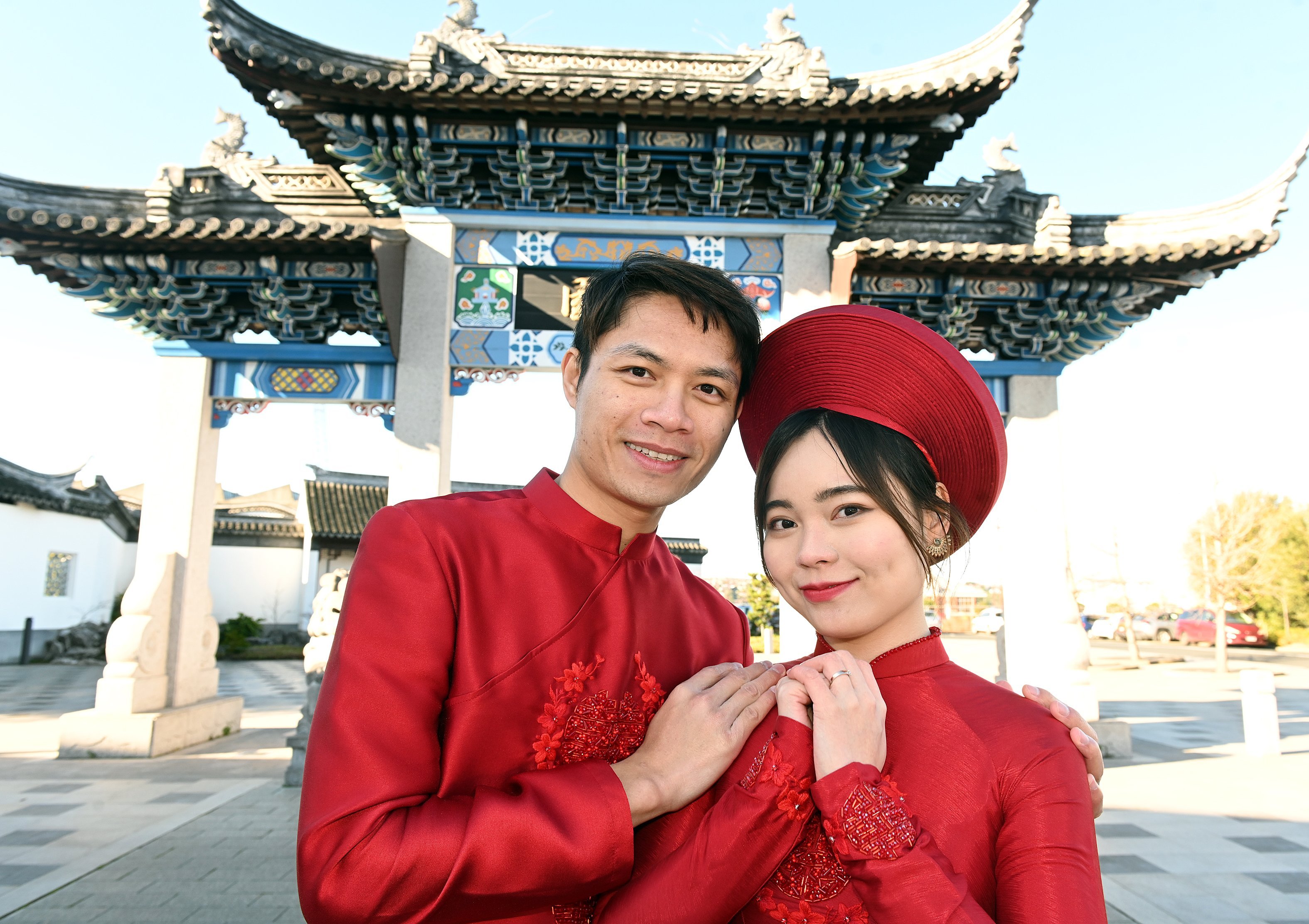 Arthur Lee and Grace Nguyen, of Auckland, dressed in traditional ao dai Vietnamese clothing,...