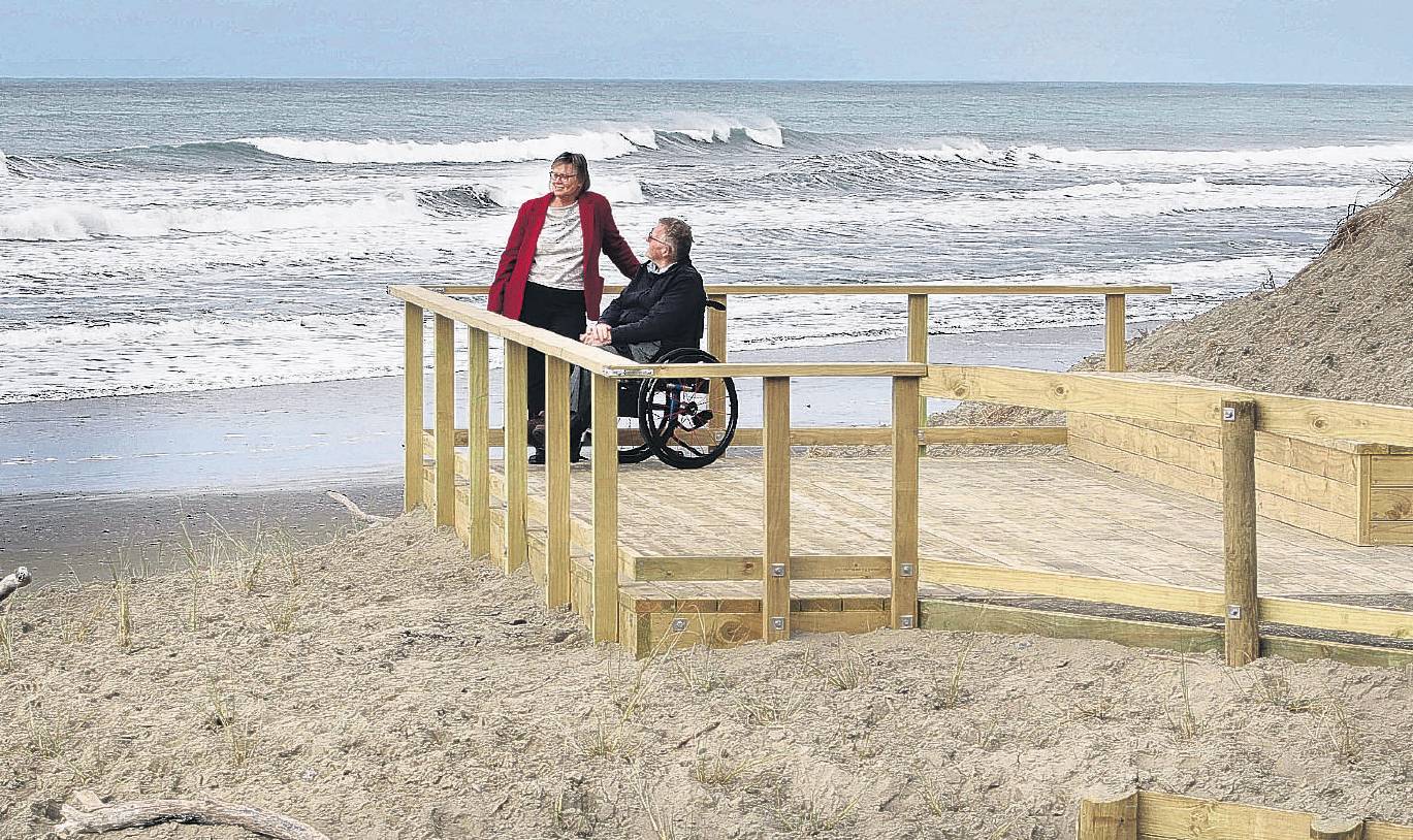 Shona Powell and Peter Boyle enjoying the view from the new deck overlooking Waikuku Beach. PHOTO...