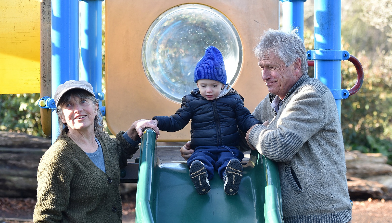 Tobia Wilkes Moller, 2, of Samoa, plays on the slide at the Dunedin Botanic Garden, watched by...