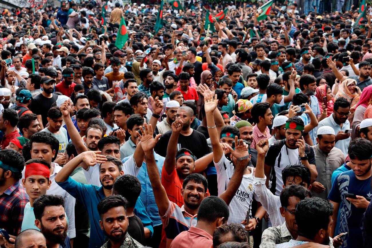 People celebrate in Dhaka after the resignation of Bangladeshi Prime Minister Sheikh Hasina....