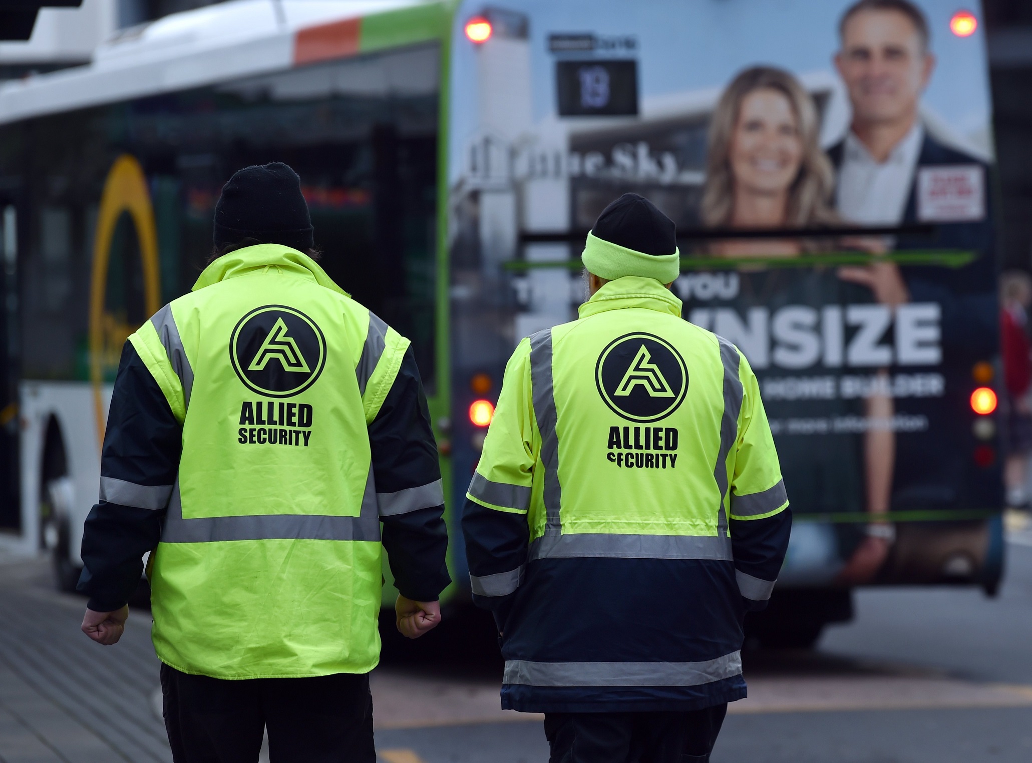 Two Allied Security employees patrol the Great King St bus hub. Photo: Peter McIntosh