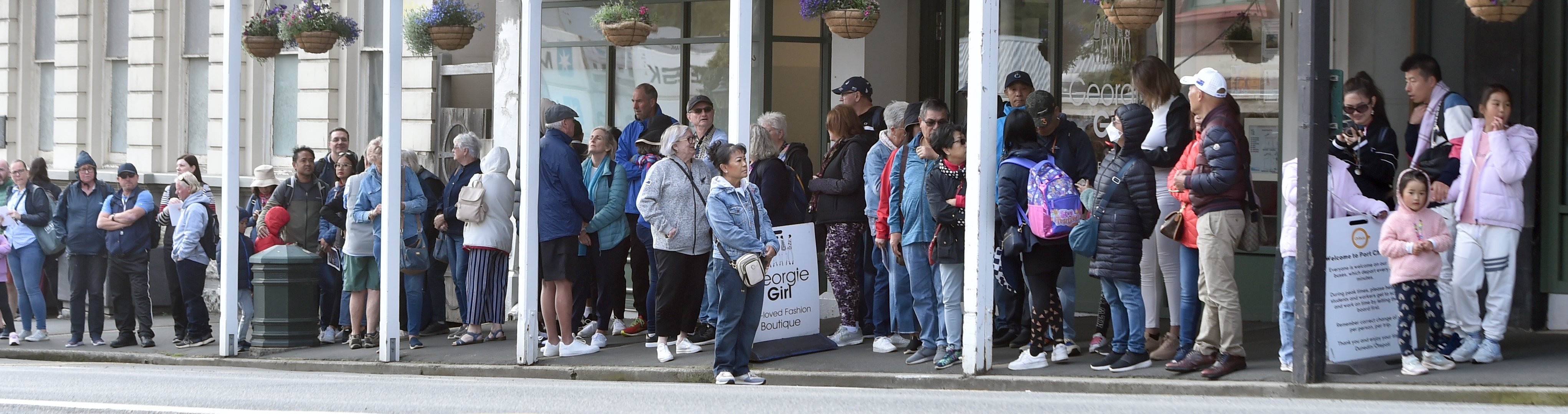 Cruise ship passengers wait for buses at Port Chalmers on New Year's Day. PHOTO: PETER MCINTOSH