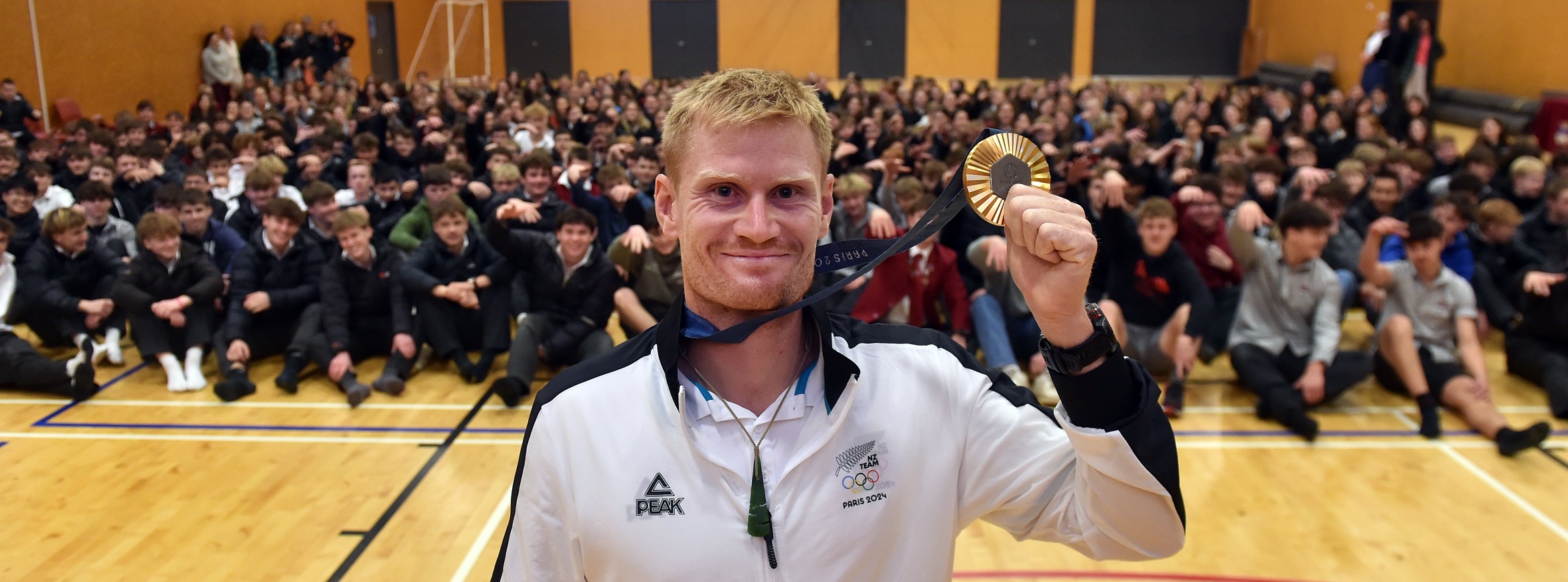 Former Dunstan High School student Finn Butcher shows off his gold medal from the kayak cross at...