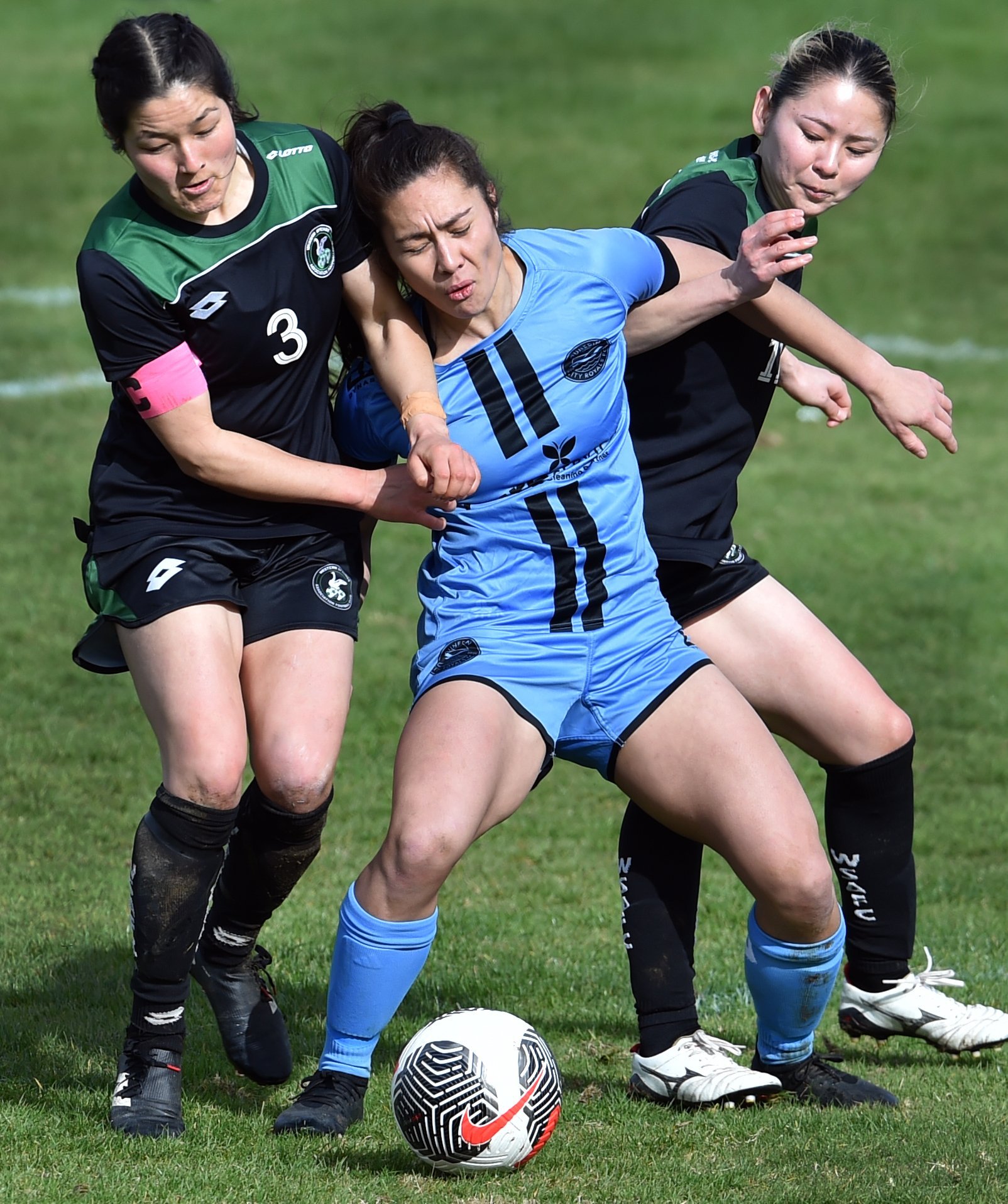 Royals midfielder Shontelle Smith battles for the ball with Western Spring players Tiana Hill ...