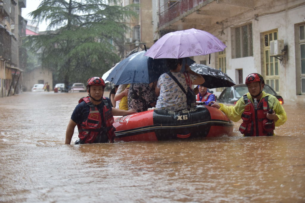 Rescuers evacuate trapped residents from a flood-affected in Loudi, in China's Hunan Province....