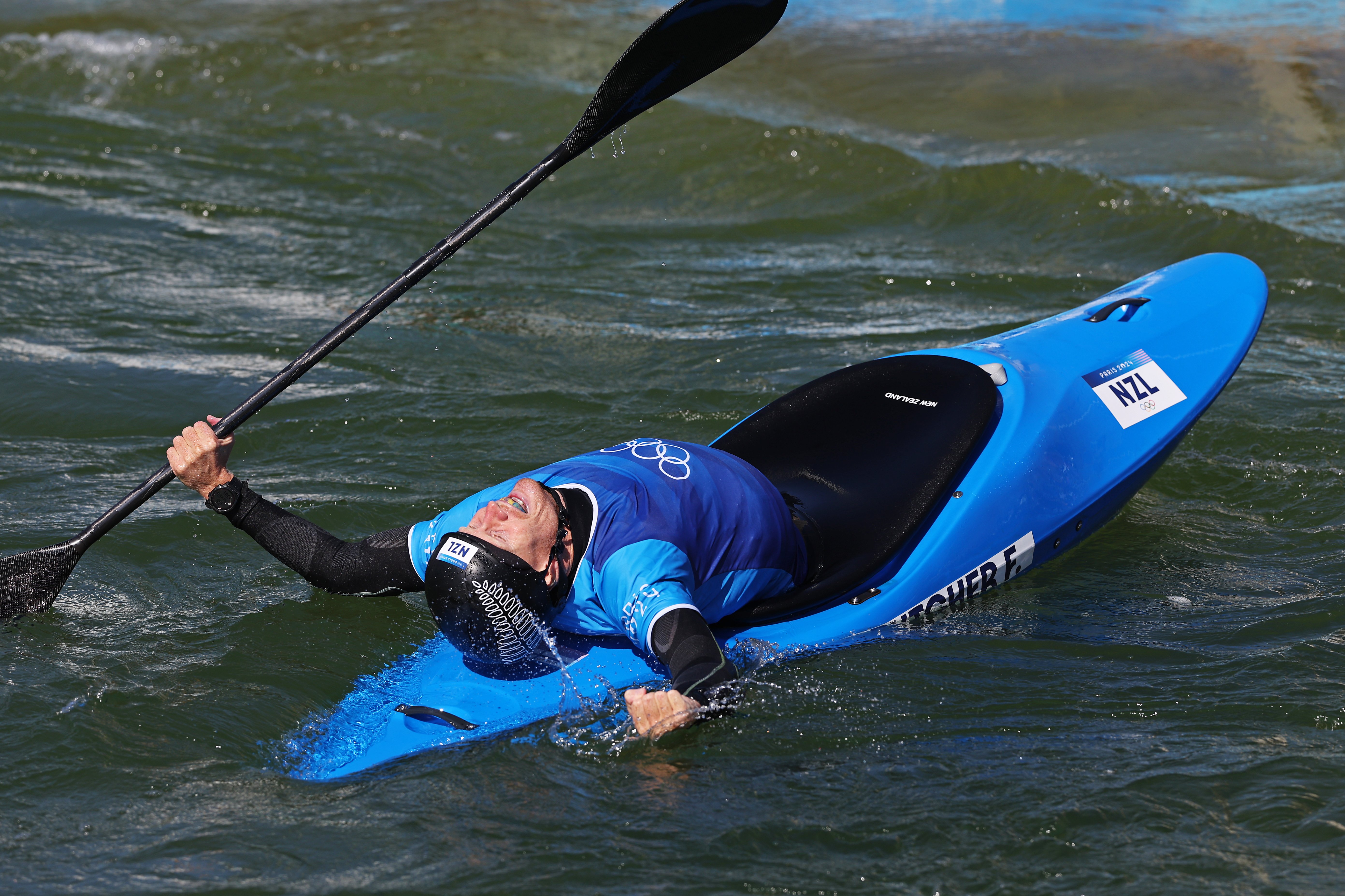 New Zealander Finn Butcher celebrates after winning gold in the kayak cross final at Vaires-Sur...