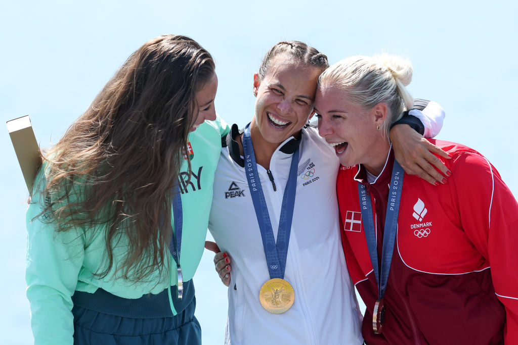 Dame Lisa Carrington (C) with Hungary's silver medallist Tamara Csipes (L) and Denmark's bronze...