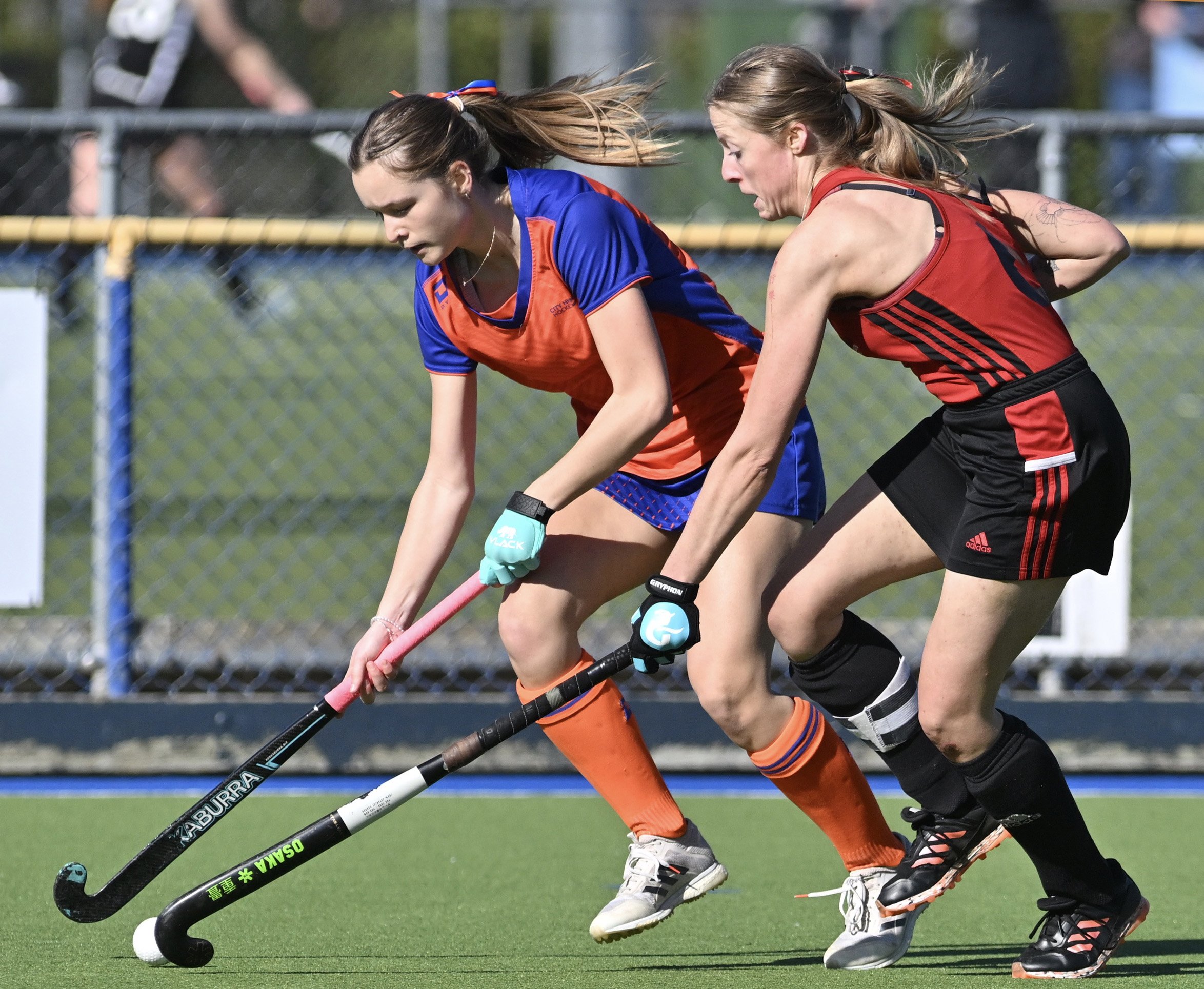 Mary Flatman (left) tries to get something going for the City Highlanders despite attention from...