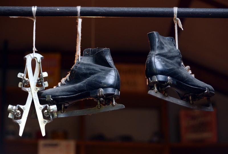 Ice skates hang from the ceiling.