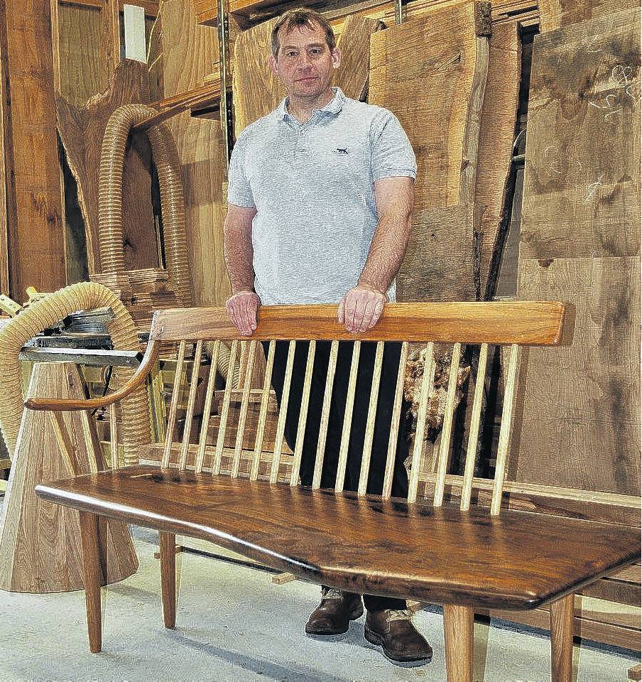 David Laird in his workshop with a handcrafted Shaker bench seat, inspired by George Nakashima, a...