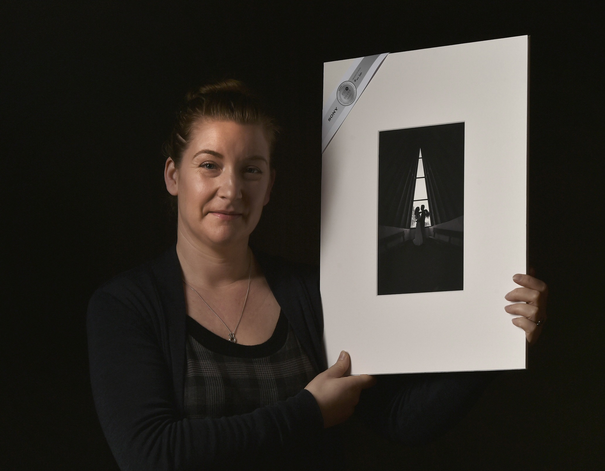 Kelk Photography owner Nicola Wilhelmsen holds her silver shot "The Couple in the Chapel", taken...