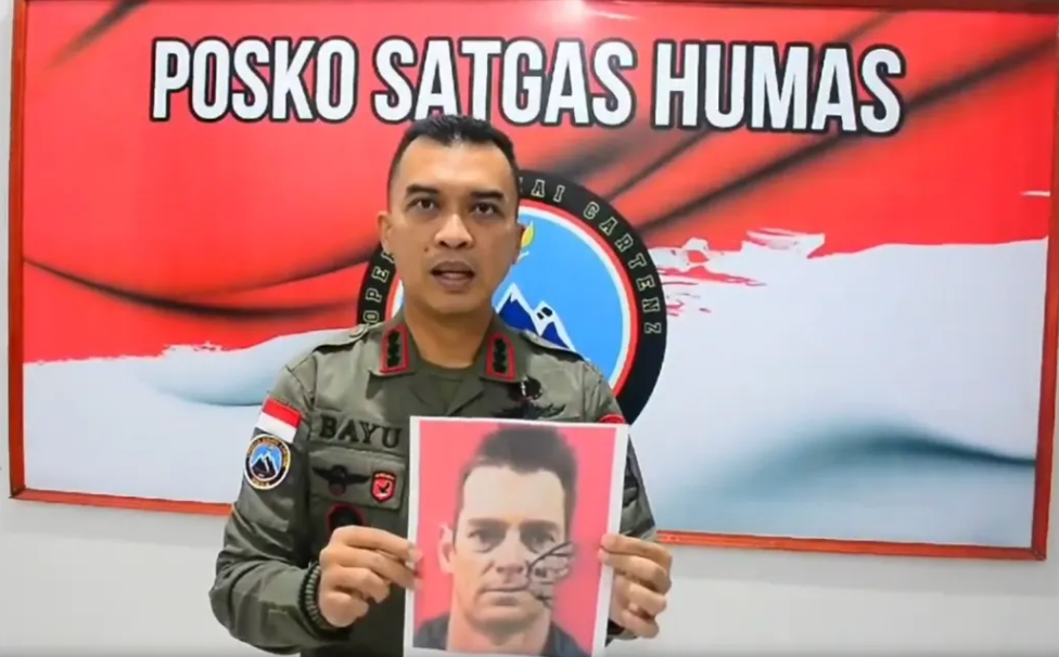 An Indonesian police spokesman holds up a photo of Glen Malcolm Conning in a video. Photo:...