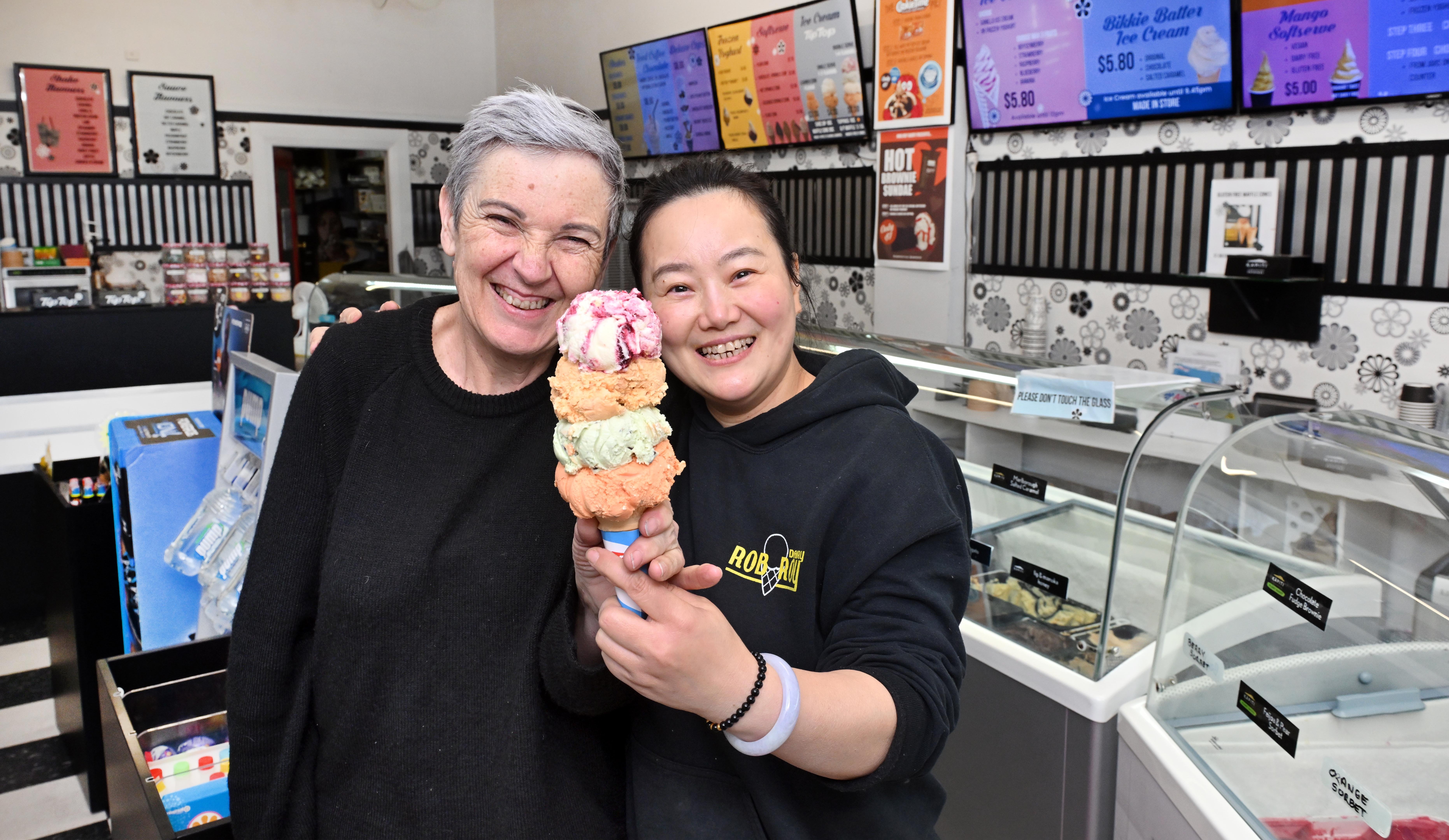 Former Rob Roy Dairy owner Liz Watson hands the baton (also known as an ice cream) to new owner...