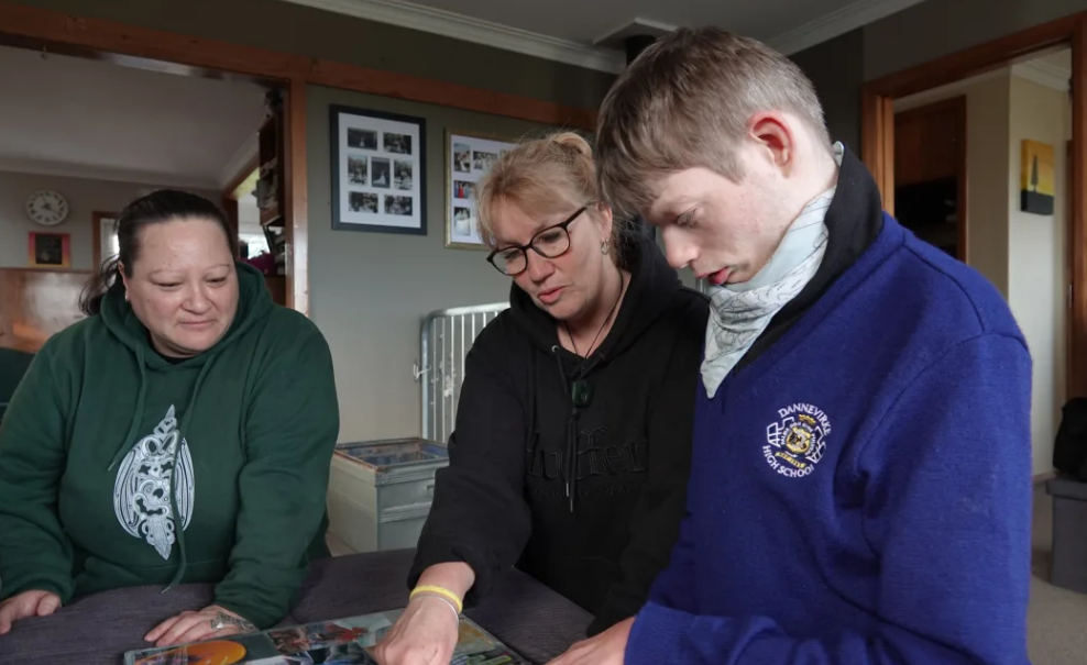 Ryan, with carer Trishna Williams, left, and mum Pip Cook, centre. Photo: RNZ