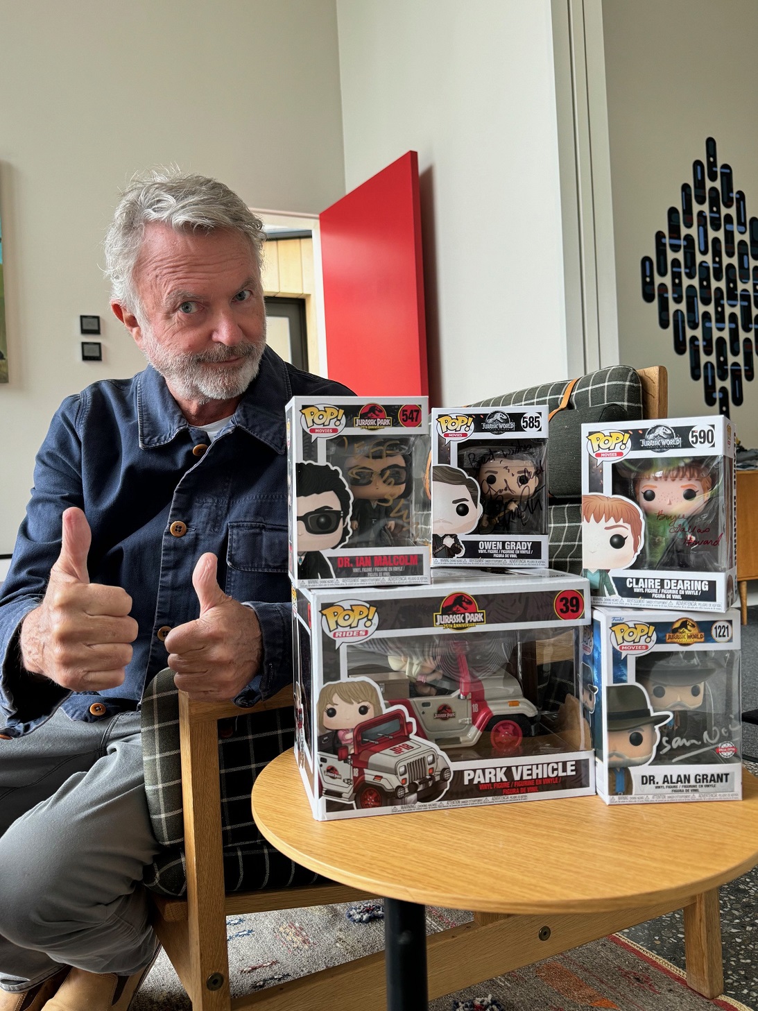 Hollywood actor Sir Sam Neill with his beloved personal collection of autographed Funko Pop...