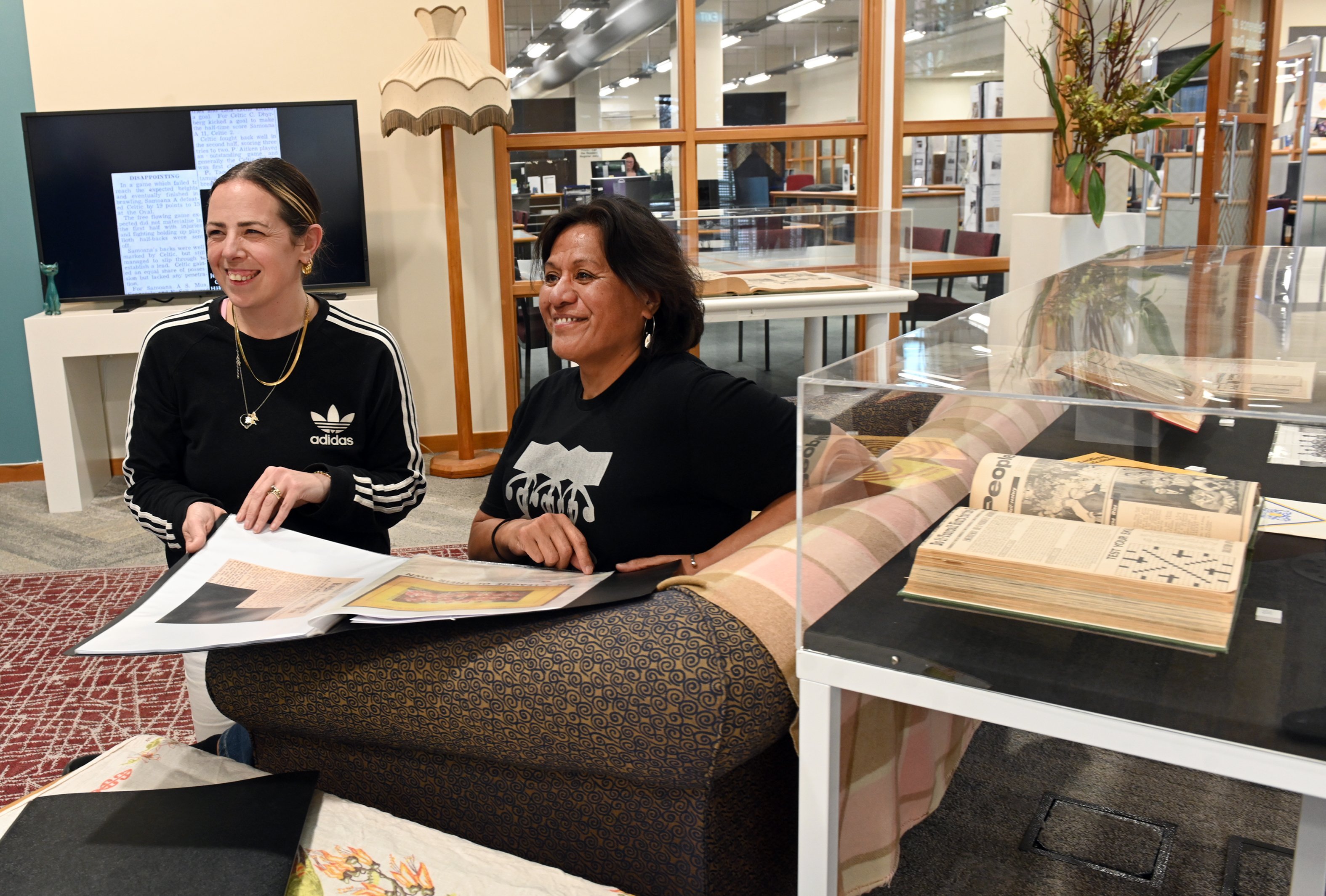 Hocken Library senior collections assistant Ceri Austin-Hart (left) flicks through some of the...