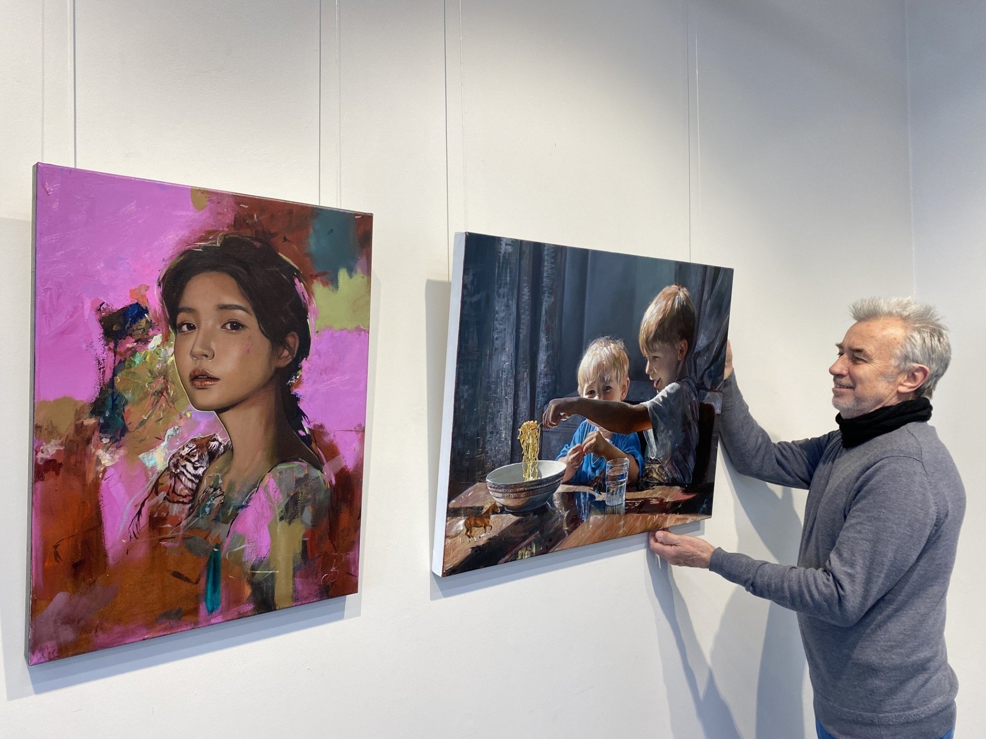 Otago Art Society councillor and exhibition lead for "The Ultimate Showcase" Rob McGee adjusts...