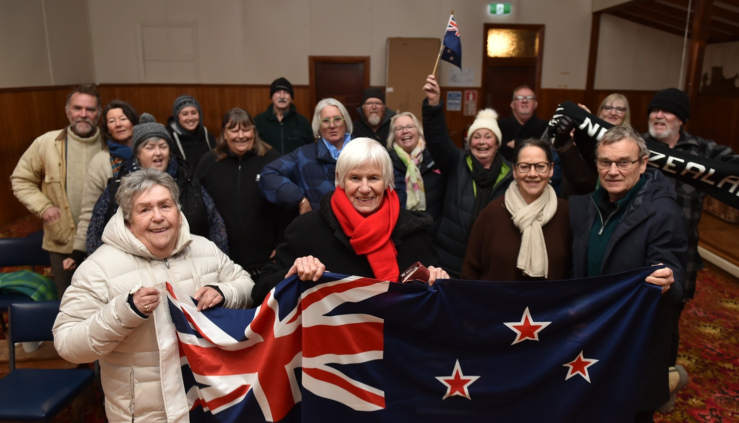 Val Butcher (centre) and a group of Ophir residents cheering on Finn Butcher earlier in his...