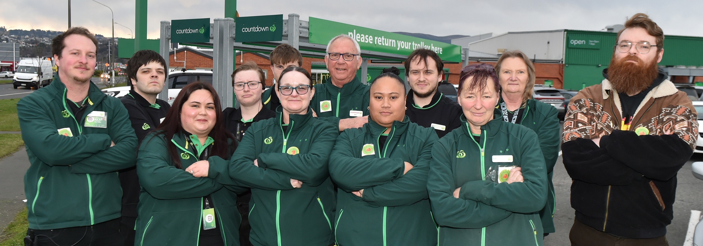 First Union representative Angus Wilson (far right) stands with staff members outside Woolworths...