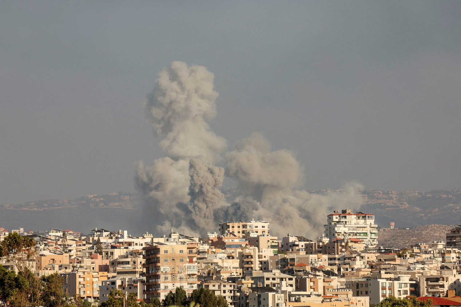 Smoke rises amid ongoing cross-border hostilities between Hezbollah and Israeli forces in...