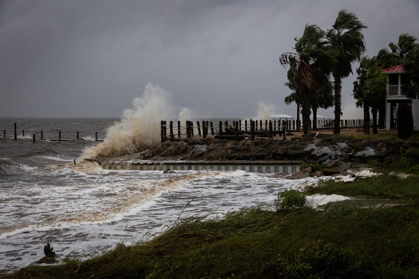 Waves crash against a house seawall in Eastpoint, Florida as Hurricane Helene intensifies before...